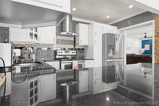 96164 S Strayhorn Heights Rd, Gore, OK 74435 - kitchen with stainless steel appliances, wall chimney range hood, a ceiling fan, tasteful backsplash, and glass insert cabinets