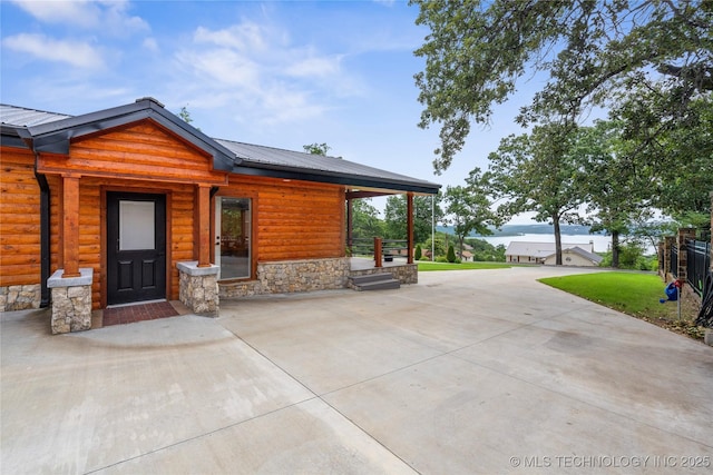 96164 S Strayhorn Heights Rd, Gore, OK 74435 - view of front facade featuring faux log siding, a front lawn, a metal roof, and stone siding
