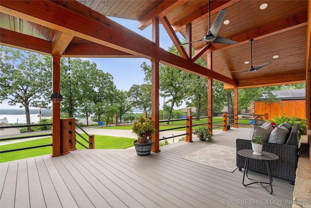 96164 S Strayhorn Heights Rd, Gore, OK 74435 - wooden deck featuring a water view, a ceiling fan, and a lawn