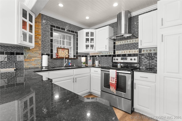 96164 S Strayhorn Heights Rd, Gore, OK 74435 - kitchen with electric range, wall chimney range hood, glass insert cabinets, white cabinets, and recessed lighting