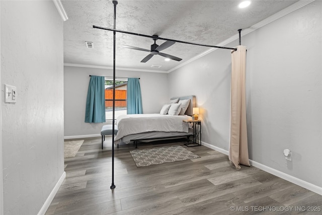 96164 S Strayhorn Heights Rd, Gore, OK 74435 - bedroom with crown molding, wood finished floors, ceiling fan, recessed lighting, and a textured ceiling