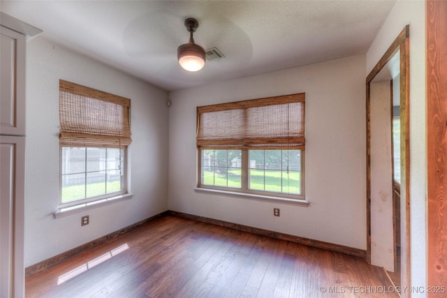 17542 W 1st St S, Sand Springs, OK 74063 - unfurnished room featuring plenty of natural light, ceiling fan, and wood finished floors