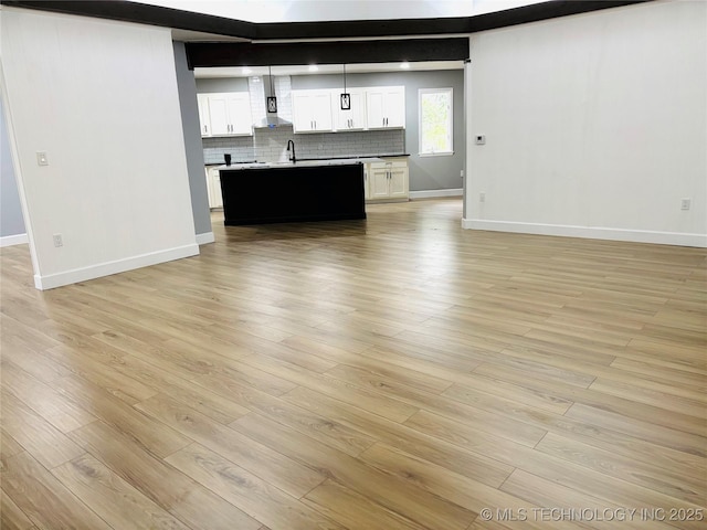 3622 S 82nd E Ave, Tulsa, OK 74145 - unfurnished living room featuring baseboards and light wood finished floors