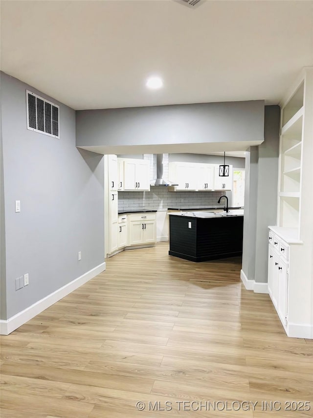 3622 S 82nd E Ave, Tulsa, OK 74145 - kitchen featuring wall chimney range hood, tasteful backsplash, light wood-type flooring, white cabinets, and recessed lighting