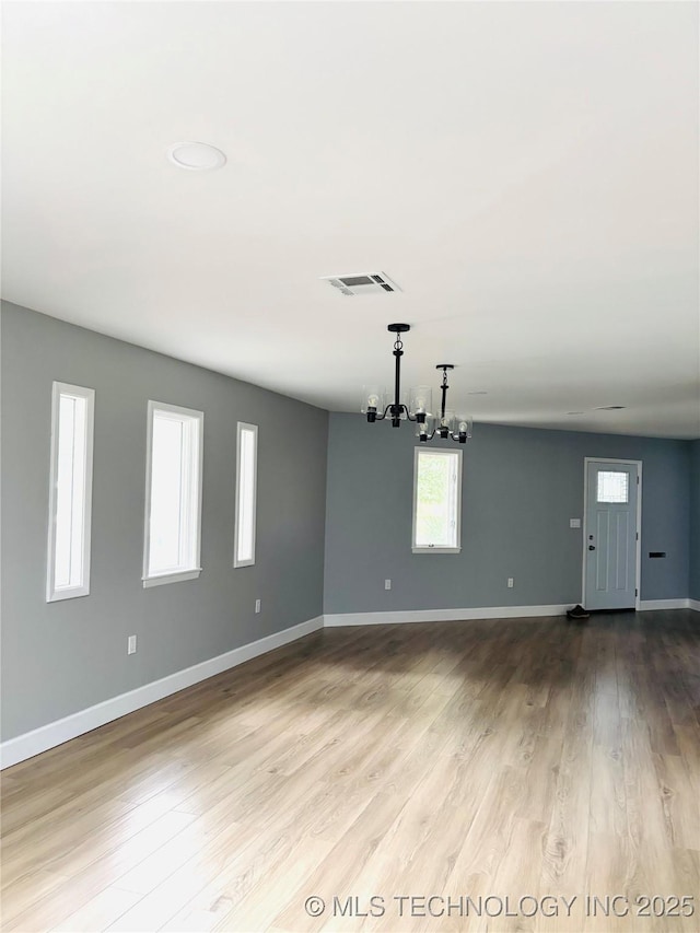 3622 S 82nd E Ave, Tulsa, OK 74145 - unfurnished room with a chandelier and wood finished floors