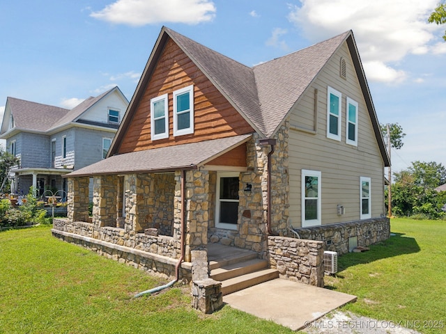 521 S Chickasaw Ave, Claremore, OK 74017 - view of front of house with stone siding, roof with shingles, and a front lawn