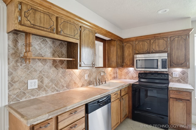 521 S Chickasaw Ave, Claremore, OK 74017 - kitchen with appliances with stainless steel finishes, decorative backsplash, brown cabinets, a textured ceiling, and light tile patterned floors