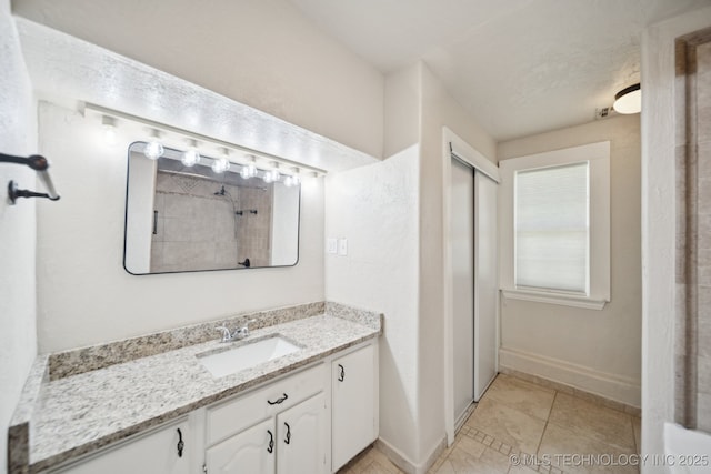 521 S Chickasaw Ave, Claremore, OK 74017 - bathroom featuring vanity, tile patterned flooring, and a shower