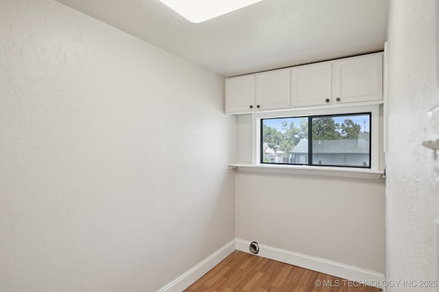 521 S Chickasaw Ave, Claremore, OK 74017 - washroom featuring cabinet space and light wood-type flooring