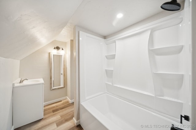 521 S Chickasaw Ave, Claremore, OK 74017 - full bath with vanity, wood finished floors, vaulted ceiling, and shower / bath combination