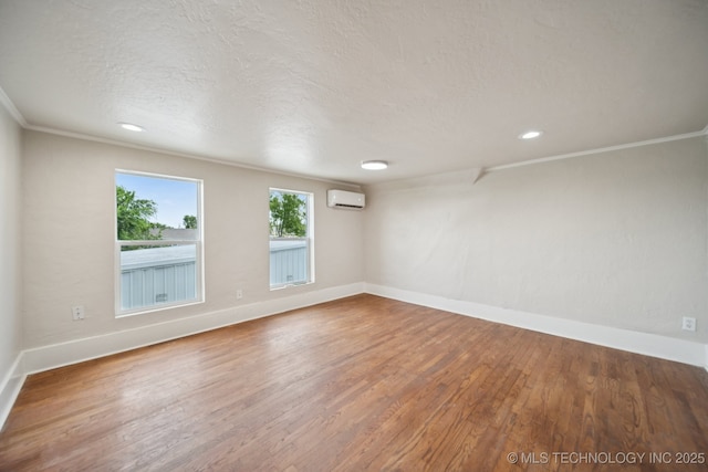 521 S Chickasaw Ave, Claremore, OK 74017 - spare room with a wall mounted AC, wood finished floors, crown molding, recessed lighting, and a textured ceiling