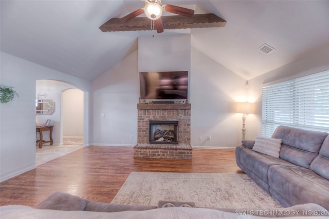 5440 Skylane Pl, Sand Springs, OK 74063 - living room featuring ceiling fan, arched walkways, wood finished floors, and a brick fireplace