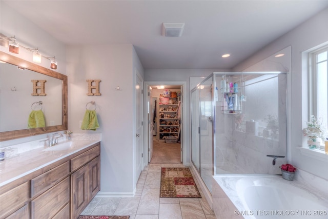 5440 Skylane Pl, Sand Springs, OK 74063 - full bathroom with a stall shower, vanity, a bath, a walk in closet, and tile patterned floors