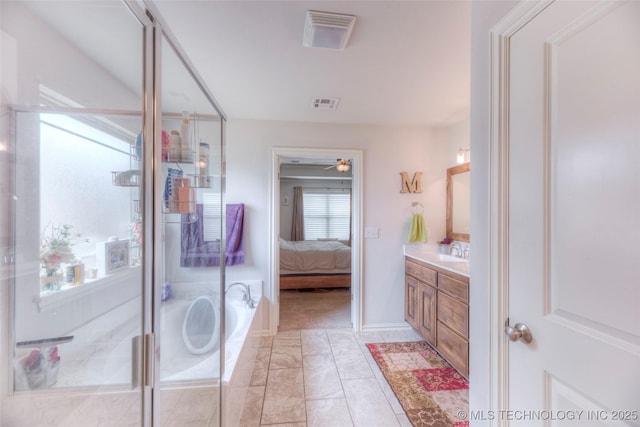 5440 Skylane Pl, Sand Springs, OK 74063 - bathroom with vanity, a stall shower, ceiling fan, a bath, and ensuite bath