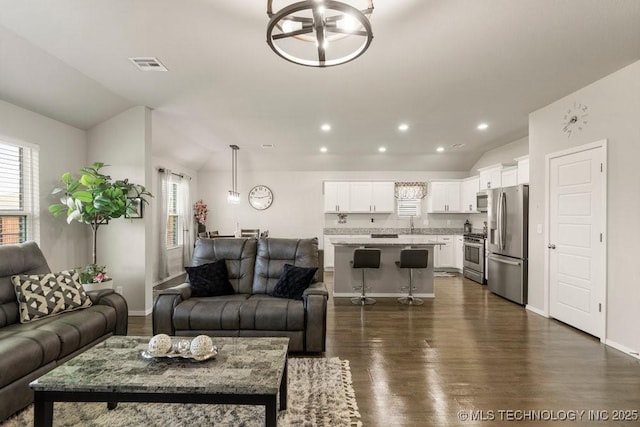 7506 E 159th St S, Bixby, OK 74008 - living area featuring vaulted ceiling, dark wood-type flooring, and recessed lighting