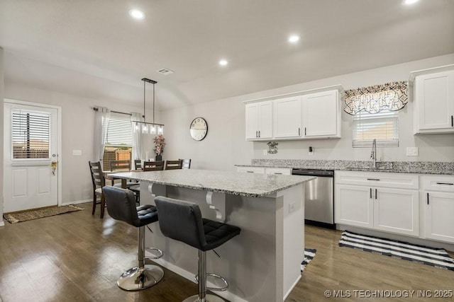 7506 E 159th St S, Bixby, OK 74008 - kitchen with stainless steel dishwasher, a center island, dark wood-style floors, a breakfast bar, and recessed lighting