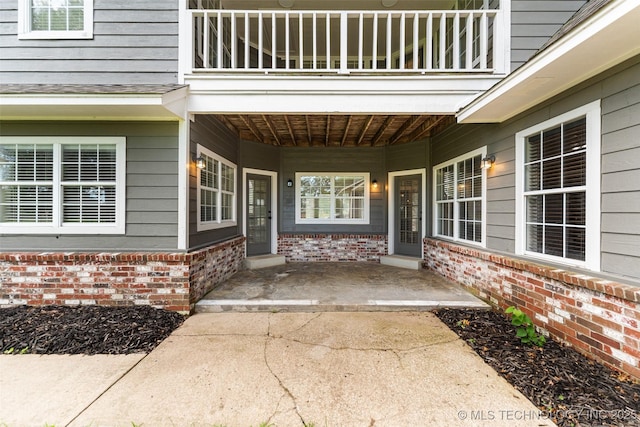 10295 E Rose Glen Dr, Claremore, OK 74019 - entrance to property with a balcony, brick siding, and a porch