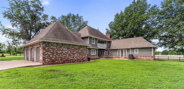 10295 E Rose Glen Dr, Claremore, OK 74019 - rear view of property featuring brick siding, a chimney, and driveway