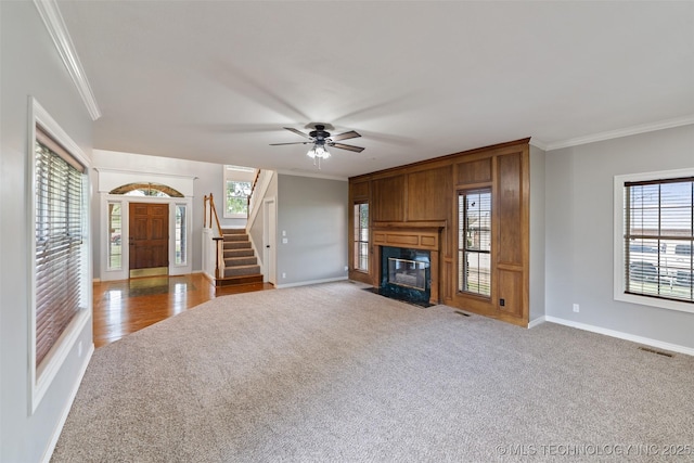 10295 E Rose Glen Dr, Claremore, OK 74019 - unfurnished living room featuring ornamental molding, carpet flooring, a fireplace, stairs, and a ceiling fan