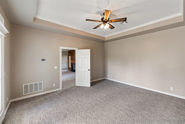 10295 E Rose Glen Dr, Claremore, OK 74019 - unfurnished room featuring a tray ceiling, carpet, a ceiling fan, and ornamental molding