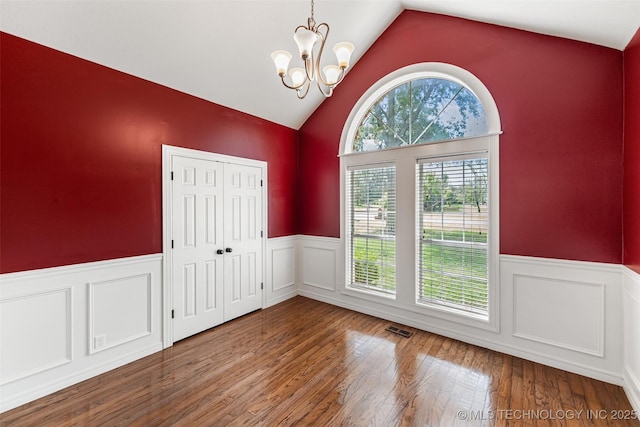 10295 E Rose Glen Dr, Claremore, OK 74019 - unfurnished dining area featuring lofted ceiling, wainscoting, a chandelier, and wood finished floors