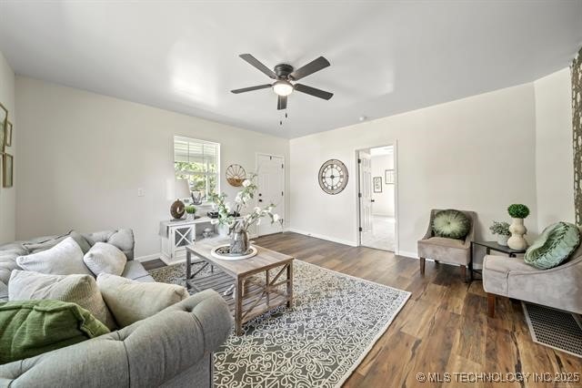 207 N Graham Ave, Wagoner, OK 74467 - living room featuring a ceiling fan and dark wood-style floors