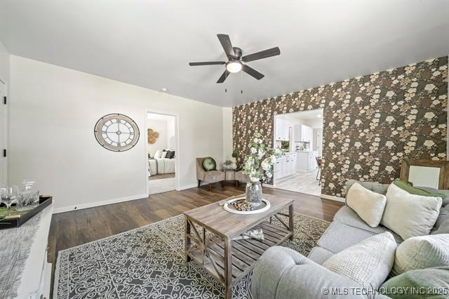 207 N Graham Ave, Wagoner, OK 74467 - living area with ceiling fan, wood finished floors, an accent wall, and wallpapered walls