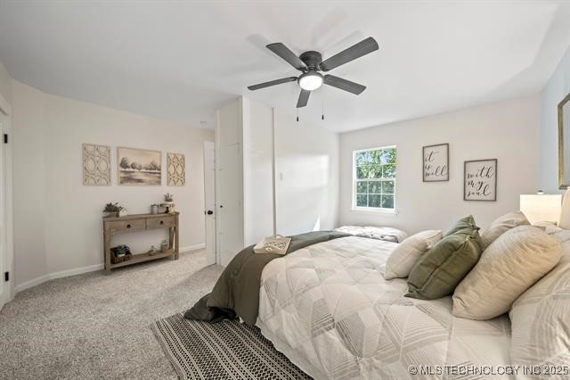 207 N Graham Ave, Wagoner, OK 74467 - carpeted bedroom featuring ceiling fan and baseboards