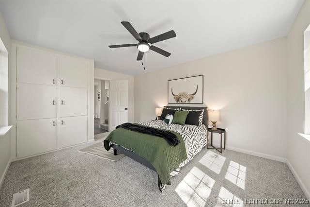 207 N Graham Ave, Wagoner, OK 74467 - bedroom with light colored carpet and ceiling fan