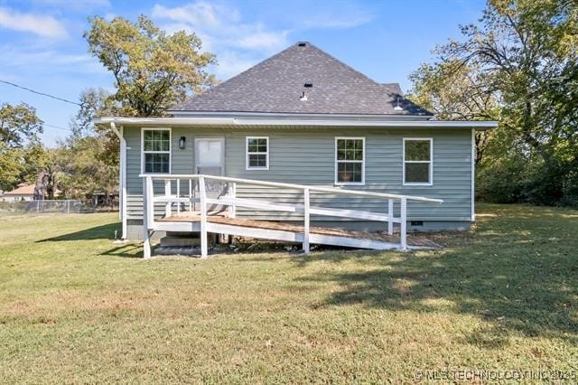 207 N Graham Ave, Wagoner, OK 74467 - rear view of house featuring a deck, a lawn, crawl space, and a shingled roof