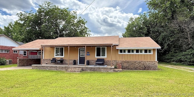102 N Ash Ave, Tahlequah, OK 74464 - view of front of home featuring a front yard and board and batten siding
