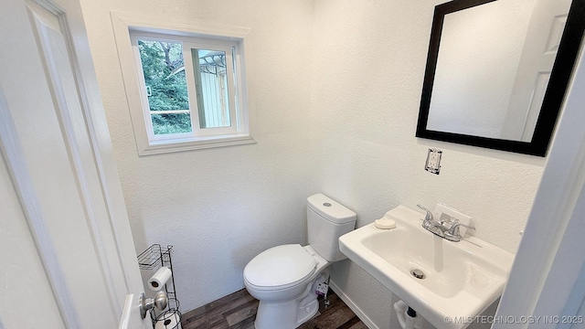 102 N Ash Ave, Tahlequah, OK 74464 - half bathroom featuring wood finished floors and a textured wall