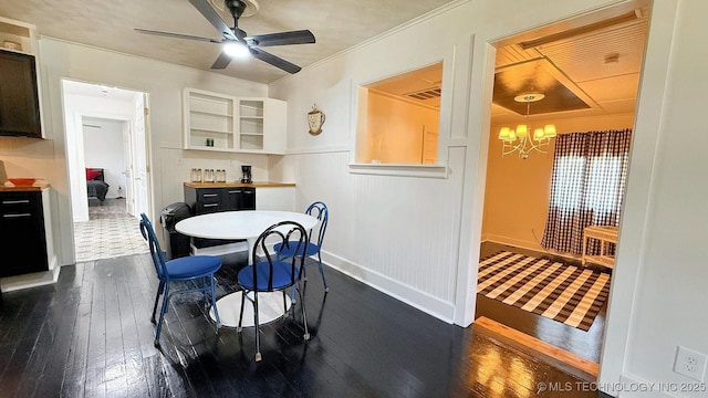 102 N Ash Ave, Tahlequah, OK 74464 - dining room featuring dark wood finished floors, a chandelier, a ceiling fan, and ornamental molding