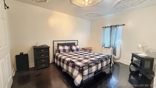 102 N Ash Ave, Tahlequah, OK 74464 - bedroom with dark wood finished floors and a wood stove