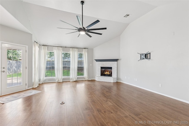 2105 W D Ct, Jenks, OK 74037 - unfurnished living room featuring lofted ceiling, ceiling fan, a fireplace, and wood finished floors