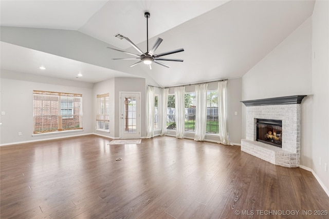 2105 W D Ct, Jenks, OK 74037 - unfurnished living room featuring vaulted ceiling, ceiling fan, a fireplace, and wood finished floors