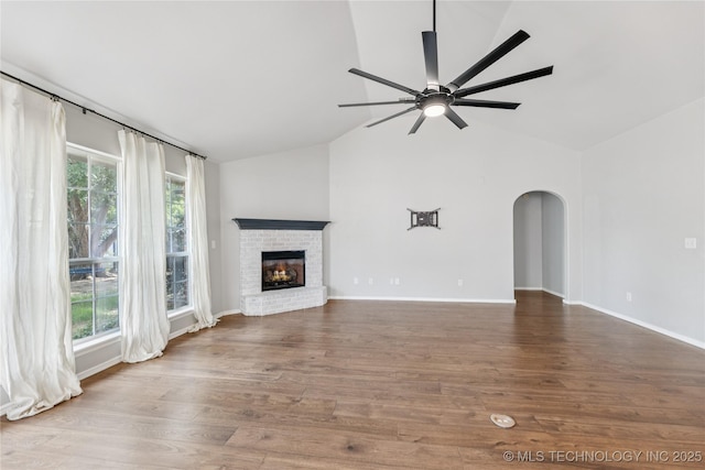 2105 W D Ct, Jenks, OK 74037 - unfurnished living room with healthy amount of natural light, a ceiling fan, arched walkways, a brick fireplace, and high vaulted ceiling