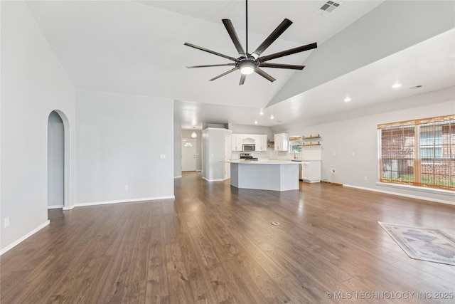 2105 W D Ct, Jenks, OK 74037 - unfurnished living room featuring a ceiling fan, dark wood-style floors, high vaulted ceiling, arched walkways, and recessed lighting