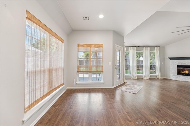 2105 W D Ct, Jenks, OK 74037 - unfurnished living room with plenty of natural light, wood finished floors, a fireplace, lofted ceiling, and ceiling fan