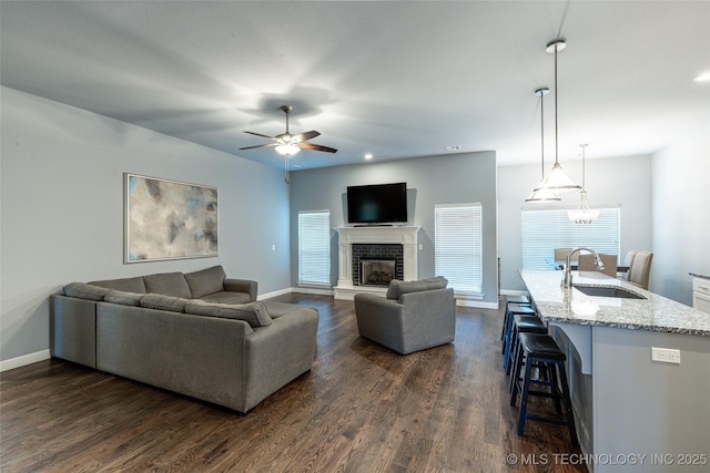 26615 Duck Pond Ln, Claremore, OK 74019 - living area featuring ceiling fan, dark wood finished floors, a brick fireplace, and recessed lighting