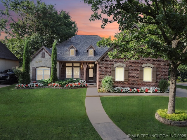 701 E 119th St, Jenks, OK 74037 - view of front of house featuring brick siding and a yard