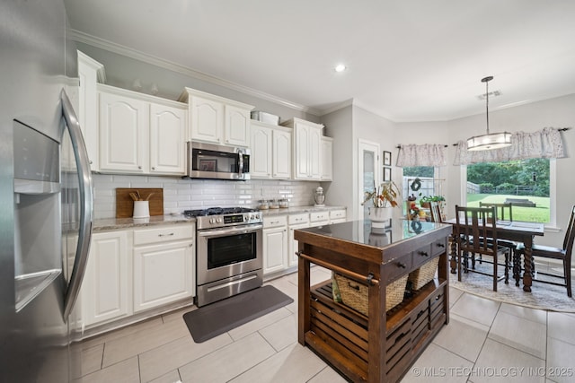 701 E 119th St, Jenks, OK 74037 - kitchen featuring appliances with stainless steel finishes, backsplash, white cabinetry, light stone counters, and decorative light fixtures