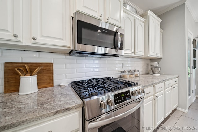 701 E 119th St, Jenks, OK 74037 - kitchen featuring stainless steel appliances, white cabinetry, crown molding, backsplash, and light stone countertops