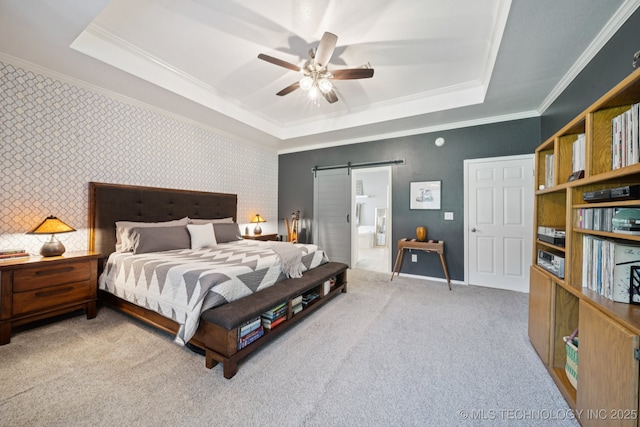 701 E 119th St, Jenks, OK 74037 - carpeted bedroom featuring a raised ceiling, ornamental molding, a barn door, ensuite bath, and a ceiling fan