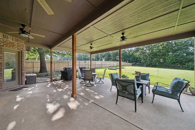 701 E 119th St, Jenks, OK 74037 - fenced backyard with a ceiling fan, a grill, a patio area, outdoor dining space, and an outdoor hangout area