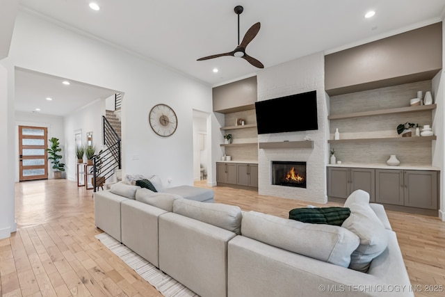 6684 E 128th St S, Bixby, OK 74008 - living area with a ceiling fan, a large fireplace, ornamental molding, light wood finished floors, and recessed lighting