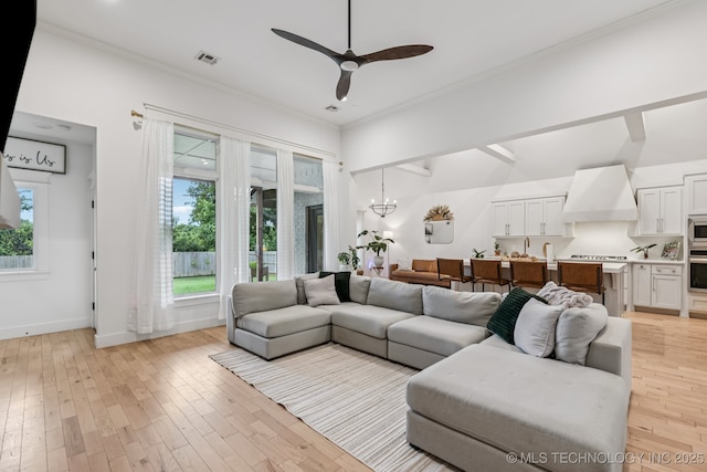 6684 E 128th St S, Bixby, OK 74008 - living area featuring plenty of natural light, a chandelier, light wood-style floors, ceiling fan, and crown molding