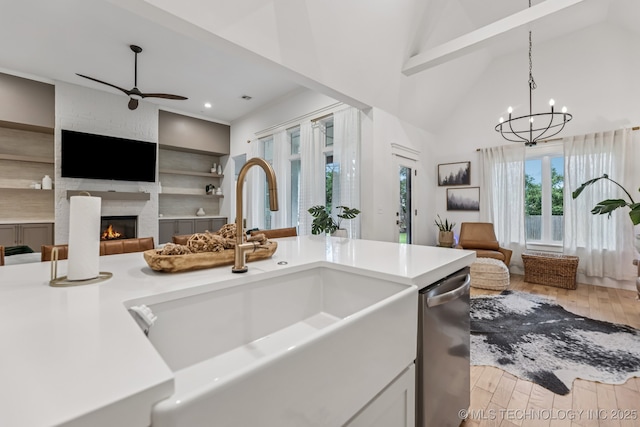 6684 E 128th St S, Bixby, OK 74008 - kitchen featuring stainless steel dishwasher, open floor plan, wood finished floors, a ceiling fan, and light countertops