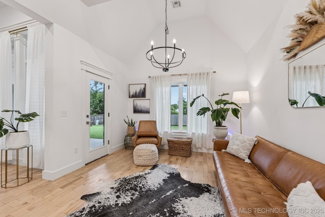 6684 E 128th St S, Bixby, OK 74008 - living area with a chandelier, plenty of natural light, wood-type flooring, and high vaulted ceiling
