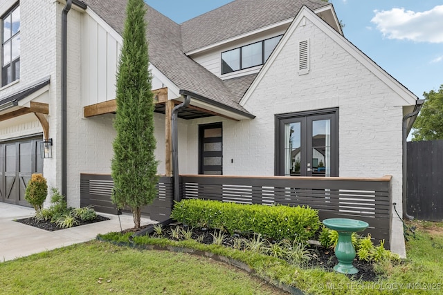 6684 E 128th St S, Bixby, OK 74008 - view of front facade with french doors, a shingled roof, and brick siding